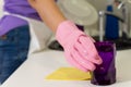 Woman placing a clean washed purple glass aside Royalty Free Stock Photo