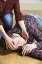 Woman Placing Man In Recovery Position After Accident Royalty Free Stock Photo