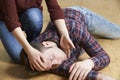 Woman Placing Man In Recovery Position After Accident Royalty Free Stock Photo