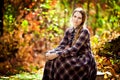 Woman in plaid dress in autumn forest. nature walks.