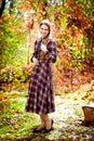 Woman in plaid dress in autumn forest. nature walks.