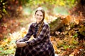 Woman in plaid dress in autumn forest. nature walks.