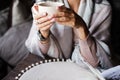 woman in a plaid holds a mug. Beautiful female hands. A cup of tea or coffee Royalty Free Stock Photo