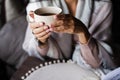 woman in a plaid holds a mug. Beautiful female hands. A cup of tea Royalty Free Stock Photo