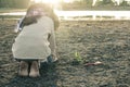 Woman planted a tree on a drought-stricken land in hopes. Royalty Free Stock Photo