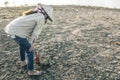 Woman planted a tree on a drought-stricken land. Royalty Free Stock Photo