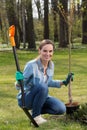 Woman planting young tree