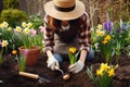 A woman plants flowers in the garden. Gardening concept.