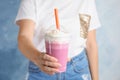 Woman with plastic cup of tasty milk shake on color background Royalty Free Stock Photo