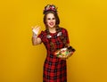 Woman with plate of Halloween candies calling to come closer