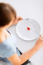 Woman with plate and one tomato Royalty Free Stock Photo