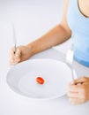 Woman with plate and one tomato