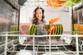 Woman With Plate View From Inside The Dishwasher Royalty Free Stock Photo