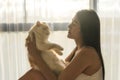 woman play with cat in room at sunset Royalty Free Stock Photo