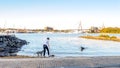Woman play with dogs at coast of Rozelle Bay near Federal Park Royalty Free Stock Photo