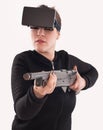 Woman play VR shooter game with vr glasses and rifle