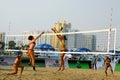 Woman player spiking in beach volleyball game