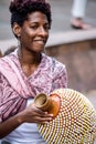 Woman playing Abe or Xequere, percussion musical instrument created in Africa