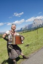 Woman playing accordion, yodeling in Alps Royalty Free Stock Photo