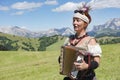 Woman playing accordion, yodeling in Alps Royalty Free Stock Photo