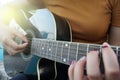 Woman playing acoustic guitar. guitar closeup