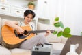 Woman playing acoustic guitar music instrument at home Royalty Free Stock Photo