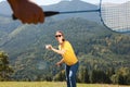 Woman playing badminton in mountains on sunny day Royalty Free Stock Photo