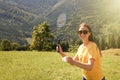 Woman playing badminton in mountains on sunny day. Space for text Royalty Free Stock Photo