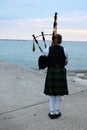 Woman playing the Bagpipes at Lake Huron in Kincardine Royalty Free Stock Photo