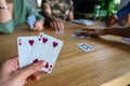 Woman playing with cards with friends close up Royalty Free Stock Photo