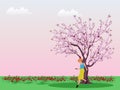 Woman playing cell phone under cherry tree in green field with pink sky  background Royalty Free Stock Photo