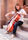 Woman playing cello on the stairway
