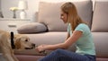 Woman playing with cute labrador dog with pet toy, domestic animal, best friend