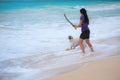 Woman playing with dog fetching stick Royalty Free Stock Photo