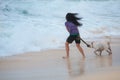 Woman playing with dog fetching stick