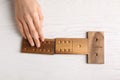 Woman playing dominoes at white table, top view Royalty Free Stock Photo