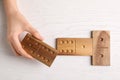 Woman playing dominoes at white table, top view Royalty Free Stock Photo