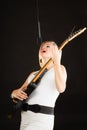 Woman playing on electric guitar and singing