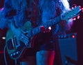 Woman playing electric guitar on stage Royalty Free Stock Photo