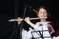 Woman playing the flute celtic medieval music in traditional scottish clothes