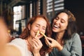 Woman playing with food and laughing in restaurant Royalty Free Stock Photo