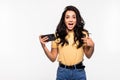 Young woman playing games in her phone isolated over a white background Royalty Free Stock Photo