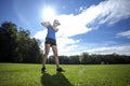 Woman playing golf on field Royalty Free Stock Photo