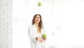 Woman playing with green apple over white background Royalty Free Stock Photo