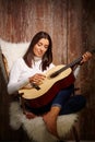 Woman playing guitar eyes closed Royalty Free Stock Photo