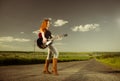 Woman playing guitar at freeway