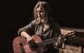 Woman playing guitar, holding an acoustic guitar in his hands. Music concept. Girl guitarist plays. Girl play the guitar Royalty Free Stock Photo