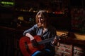 Woman playing guitar, holding an acoustic guitar in his hands. Music concept. Girl guitarist plays. Girl play the guitar Royalty Free Stock Photo