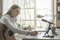 Woman playing guitar and recording her music Royalty Free Stock Photo