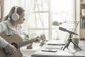 Woman playing guitar and recording her music Royalty Free Stock Photo